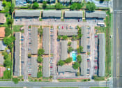 Thumbnail 29 of 29 - an aerial view of a parking lot with cars and trees