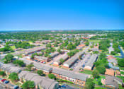 Thumbnail 27 of 29 - an aerial view of a neighborhood of houses and cars in a parking lot
