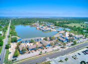 Thumbnail 24 of 24 - an aerial view of a city with a lake and a highway