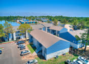 Thumbnail 23 of 24 - an aerial view of a building with a lake in the background