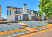 Thumbnail 40 of 40 - the front of a house with a gravel yard and a tree at Diamond Ridge Townhomes, Oklahoma City, OK 73114  