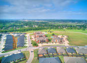 Thumbnail 12 of 14 - an aerial view of a city with houses and a field