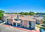 Thumbnail 26 of 29 - an aerial view of a building with cars parked in front of it at Diamond  Trail Apartments, Oklahoma City, Oklahoma