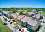 Thumbnail 27 of 29 - an aerial view of a row of houses with cars parked in a parking lot at Diamond  Trail Apartments, Oklahoma City, 73112