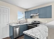 Thumbnail 2 of 40 - an updated kitchen with granite counter tops and blue cabinets at Diamond Ridge Townhomes, Oklahoma City, 73114  