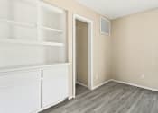 Thumbnail 22 of 40 - an empty room with white shelves and a door to a closet at Diamond Ridge Townhomes, Oklahoma City Oklahoma   