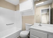 Thumbnail 26 of 40 - a bathroom with a toilet and a sink and a bath tub at Diamond Ridge Townhomes, Oklahoma City  