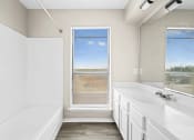 Thumbnail 18 of 40 - a bathroom with a tub and a sink and a window at Diamond Ridge Townhomes, Oklahoma ,73114