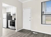 Thumbnail 13 of 40 - an empty room with a kitchen and a window and a refrigerator at Diamond Ridge Townhomes, Oklahoma ,73114