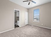 Thumbnail 16 of 40 - an empty room with a window and a ceiling fan at Diamond Ridge Townhomes, Oklahoma City, OK  