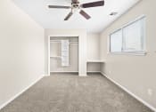 Thumbnail 17 of 40 - an empty room with a ceiling fan and a closet at Diamond Ridge Townhomes, Oklahoma   
