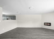 Thumbnail 32 of 40 - an empty living room with white walls and a fireplace at Diamond Ridge Townhomes, Oklahoma ,73114
