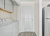 Thumbnail 37 of 40 - a white laundry room with a white refrigerator and a white door at Diamond Ridge Townhomes, Oklahoma City, OK 73114  