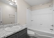 Thumbnail 35 of 40 - the preserve at ballantyne commons apartment bathroom with tub and sink and toilet at Diamond Ridge Townhomes, Oklahoma City  