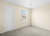 Thumbnail 34 of 40 - an empty room with a white door and a window at Diamond Ridge Townhomes, Oklahoma City, 73114  