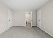 Thumbnail 33 of 40 - an empty room with two doors to a bathroom and a toilet at Diamond Ridge Townhomes, Oklahoma City Oklahoma   