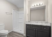 Thumbnail 36 of 40 - a bathroom with a toilet sink and shower and a mirror at Diamond Ridge Townhomes, Oklahoma City, 73114  