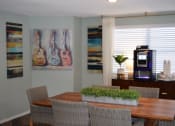 Thumbnail 12 of 19 - a dining room with a table and chairs and a coffeemaker  at Somerset Apartments, Largo