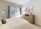 Thumbnail 10 of 35 - a bedroom with a large bed and a window