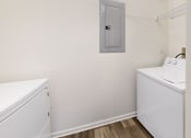 Thumbnail 13 of 35 - a small laundry room with a washer and dryer and a laundry room door