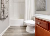 Thumbnail 26 of 35 - a bathroom with a toilet and a tub and a sink