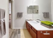 Thumbnail 22 of 35 - a bathroom with a sink and a mirror and a towel rack