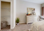 Thumbnail 21 of 35 - a bedroom with a bed and a dresser