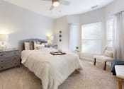Thumbnail 23 of 35 - a bedroom with a bed and a ceiling fan