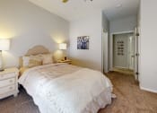 Thumbnail 20 of 35 - a bedroom with a bed and a dresser with two lamps