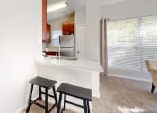 Thumbnail 15 of 35 - a kitchen with a counter and two stools