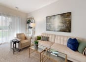 Thumbnail 18 of 35 - a living room with a couch and a table