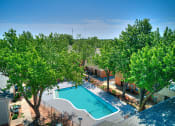 Thumbnail 23 of 29 - an aerial view of a swimming pool with trees and a resort style pool