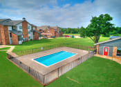 Thumbnail 8 of 14 - a backyard with a pool and a house with a fence