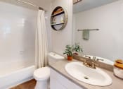 Thumbnail 9 of 19 - a bathroom with a sink toilet and a shower at Somerset Apartments, Largo, FL