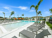 Thumbnail 23 of 36 - Sun deck next to a resort style swimming pool at Estia at Lakewood Ranch, Bradenton, Florida