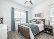 Thumbnail 6 of 46 - a bedroom with a bed and a ceiling fan at Artesia at Lakewood Ranch Apartments, Bradenton, 34211
