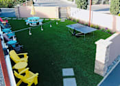 Thumbnail 6 of 11 - a backyard with synthetic grass and ping pong table