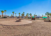 Thumbnail 20 of 26 - a park with a fire pit and benches
