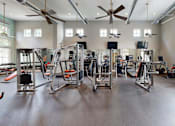 Thumbnail 26 of 34 - the gym with workout equipment at The Millennium Towne Center Apartments, Baton Rouge, Louisiana