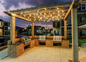 Thumbnail 32 of 37 - a brick patio with a pergola with lights on it at Annandale Apartment Homes, Tennessee