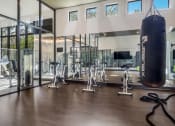 Thumbnail 21 of 35 - a home gym with a punching bag hanging from the ceiling at The Lotus at Village Walk, Fort Myers, FL