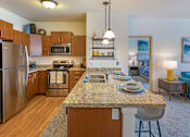 Thumbnail 3 of 50 - Kitchen with Island at The Enclave Luxury Apartments