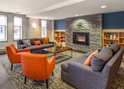 Thumbnail 25 of 50 - a living room with couches and chairs and a fireplace