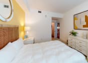 Thumbnail 9 of 35 - a bedroom with a bed and a dresser at The Lotus at Village Walk, Fort Myers, FL, 33966