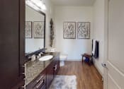 Thumbnail 8 of 24 - a bathroom with a sink mirror and toilet   at Integra 360 Apartments, Winter Springs, Florida