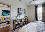 Thumbnail 10 of 24 - a bedroom with a large bed and a ceiling fan at Integra 360 Apartments, Winter Springs, FL, 32708