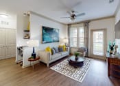 Thumbnail 3 of 24 - a living room with hardwood floors and a ceiling fan at Integra 360 Apartments, Winter Springs, FL, 32708