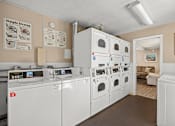 Thumbnail 11 of 11 - a laundry room with white washers and dryers