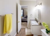 Thumbnail 9 of 27 - a bathroom with a white sink and a yellow towel