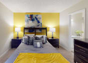 Thumbnail 7 of 27 - a bedroom with a bed and two night stands with lamps